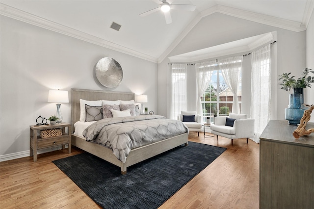 bedroom featuring crown molding, lofted ceiling, light wood-style flooring, ceiling fan, and baseboards