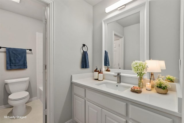 bathroom with baseboards, vanity, toilet, and shower / bathtub combination