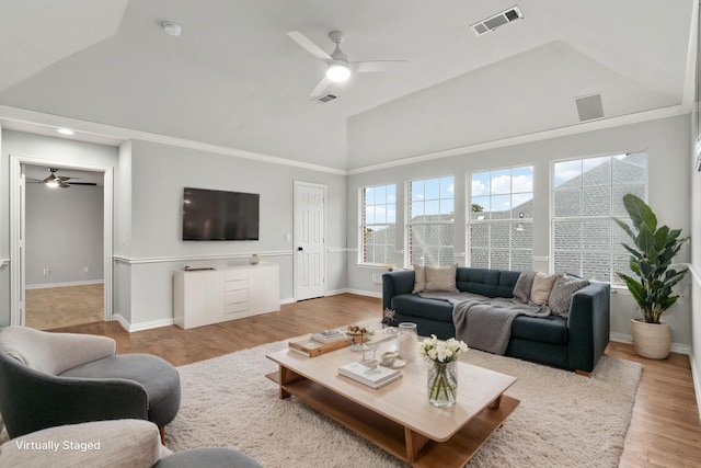 living room with visible vents, light wood-style flooring, vaulted ceiling, ceiling fan, and baseboards