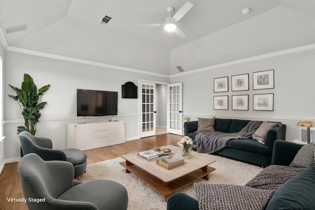 living area featuring visible vents, light wood-style flooring, ornamental molding, vaulted ceiling, and french doors