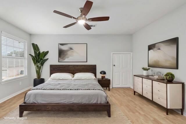 bedroom with light wood finished floors, ceiling fan, and baseboards