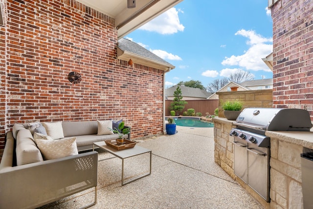 view of patio with an outdoor living space, area for grilling, fence, and a fenced in pool