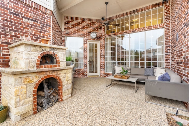 view of patio with an outdoor living space with a fireplace and ceiling fan