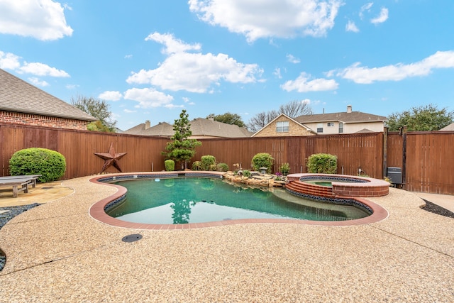 view of swimming pool with a pool with connected hot tub, a fenced backyard, and a patio