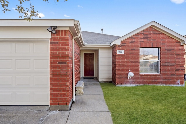 ranch-style house with a garage, brick siding, roof with shingles, and a front yard