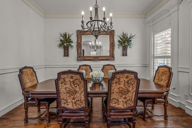 dining room featuring dark wood finished floors, crown molding, and an inviting chandelier