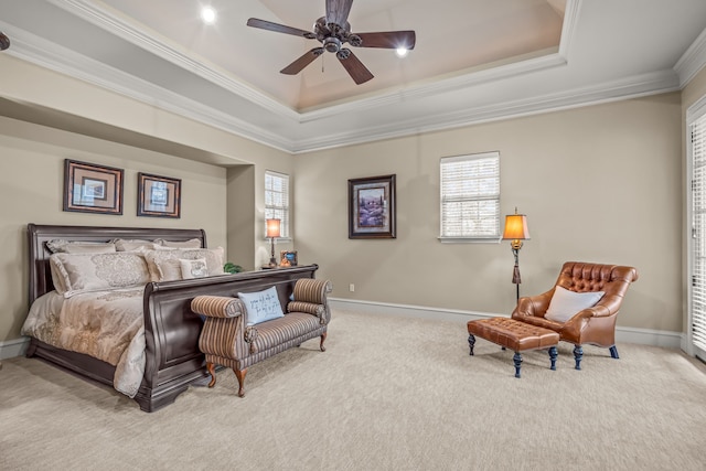 bedroom with light carpet, baseboards, a tray ceiling, and ornamental molding