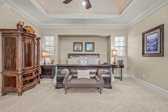 bedroom with a tray ceiling, multiple windows, carpet, and crown molding