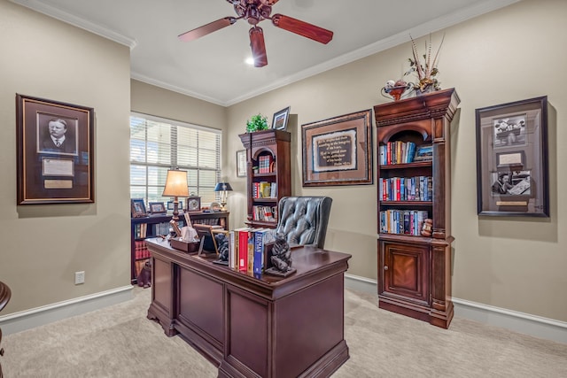 office with crown molding, baseboards, a ceiling fan, and light colored carpet