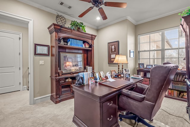 office space with light colored carpet, visible vents, ornamental molding, a ceiling fan, and baseboards