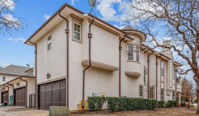 view of home's exterior with driveway and stucco siding