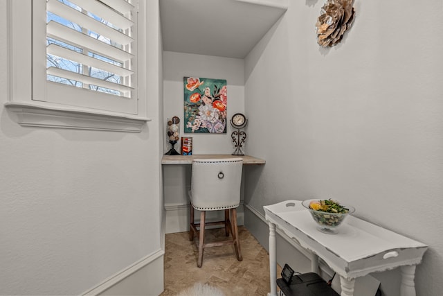 interior space featuring baseboards