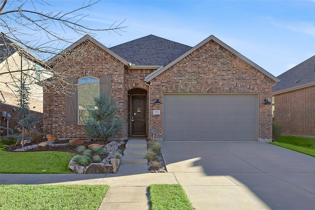 view of front facade with a garage, concrete driveway, brick siding, and roof with shingles