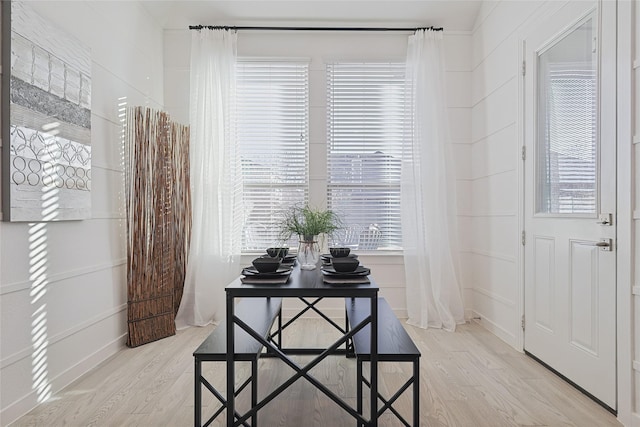 interior space featuring baseboards, a wealth of natural light, and light wood-style floors