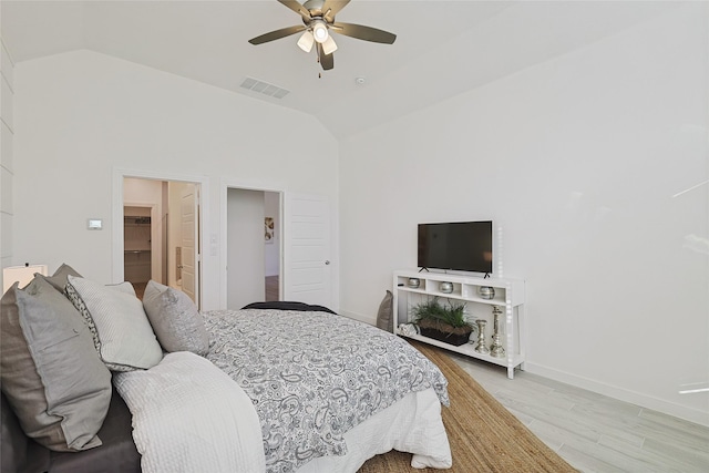 bedroom with light wood-style floors, lofted ceiling, visible vents, and baseboards