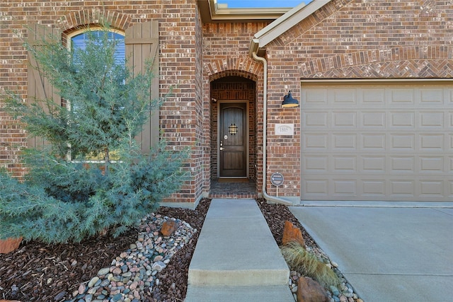 property entrance featuring brick siding and an attached garage