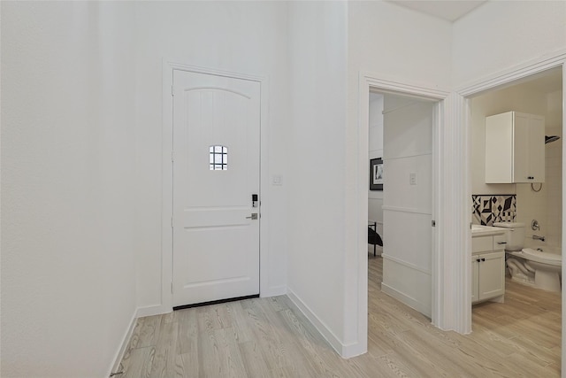 entryway featuring light wood-type flooring and baseboards