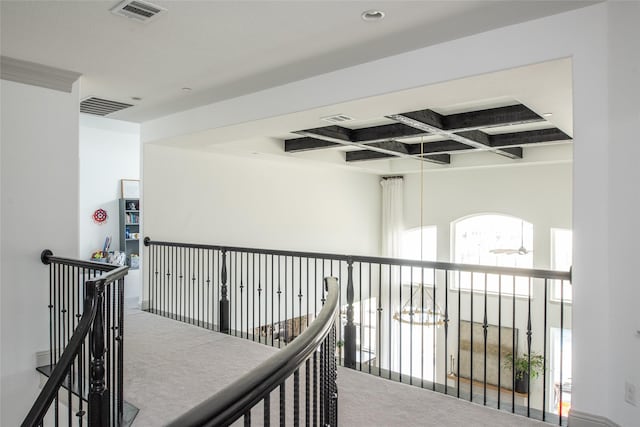 hallway with beam ceiling, visible vents, coffered ceiling, and carpet floors