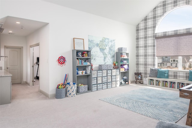 interior space with lofted ceiling, recessed lighting, carpet, and baseboards