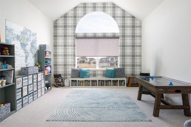 playroom with high vaulted ceiling and carpet floors