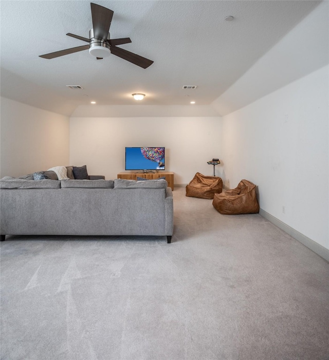 living area featuring visible vents, baseboards, light colored carpet, and vaulted ceiling