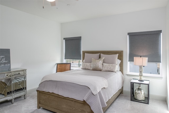 carpeted bedroom with a ceiling fan and baseboards