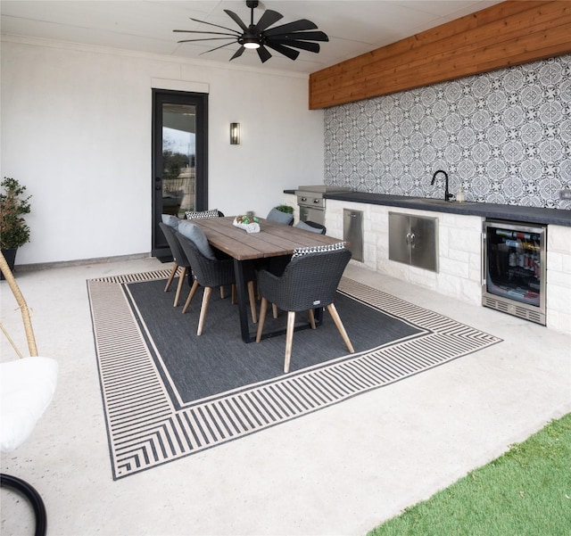 carpeted dining space featuring wine cooler, a ceiling fan, and ornamental molding