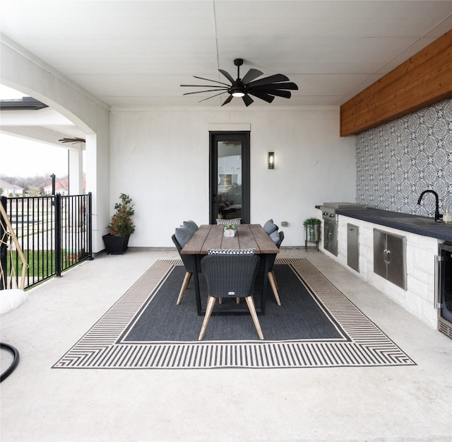 view of patio / terrace with outdoor dining area, ceiling fan, and a sink