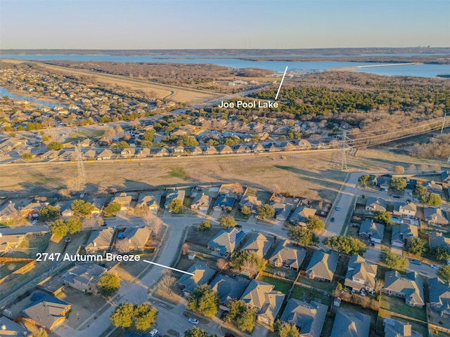 drone / aerial view with a water view and a residential view