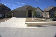 ranch-style house with a garage and driveway