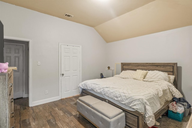 bedroom with dark wood-style floors, lofted ceiling, visible vents, and baseboards