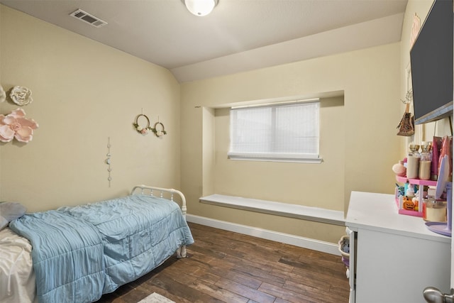 bedroom featuring lofted ceiling, baseboards, visible vents, and dark wood-type flooring