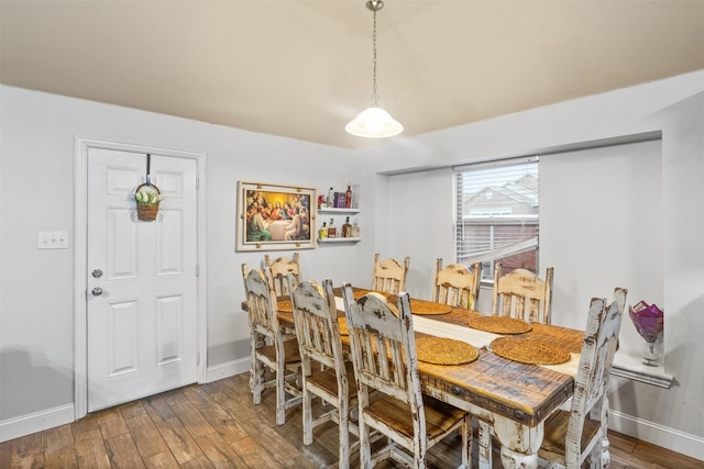 dining area with wood finished floors and baseboards