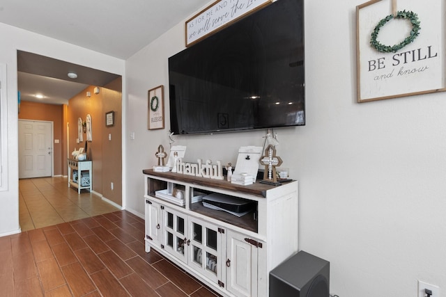 interior space with baseboards and dark wood-style flooring