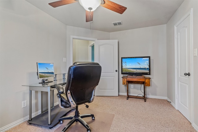 office area featuring light carpet, a ceiling fan, visible vents, and baseboards