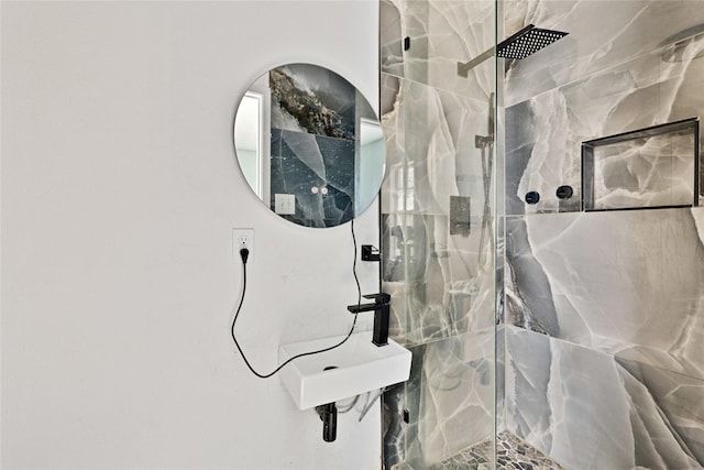 bathroom with a marble finish shower