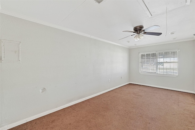 carpeted spare room with baseboards, electric panel, attic access, and crown molding