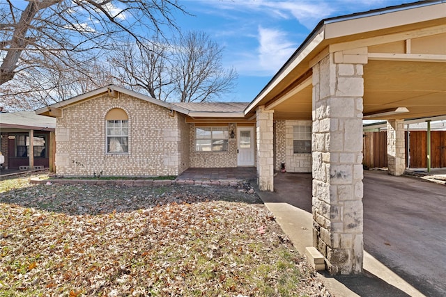 view of front of house with brick siding and fence