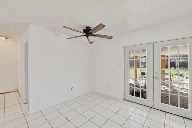 empty room with ceiling fan, light tile patterned flooring, and french doors