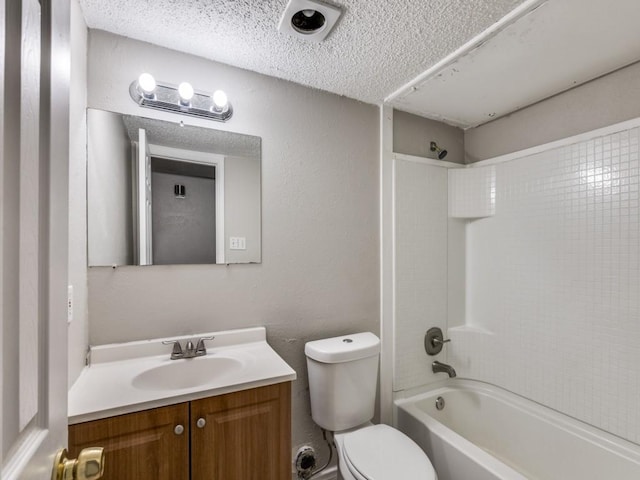 bathroom featuring washtub / shower combination, toilet, vanity, and a textured ceiling