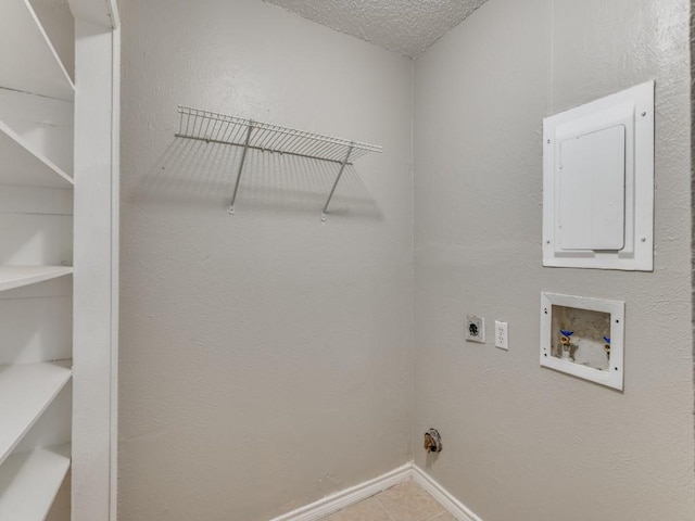 clothes washing area featuring laundry area, electric panel, hookup for an electric dryer, a textured ceiling, and washer hookup