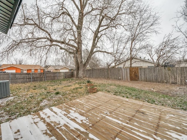 deck featuring cooling unit and a fenced backyard