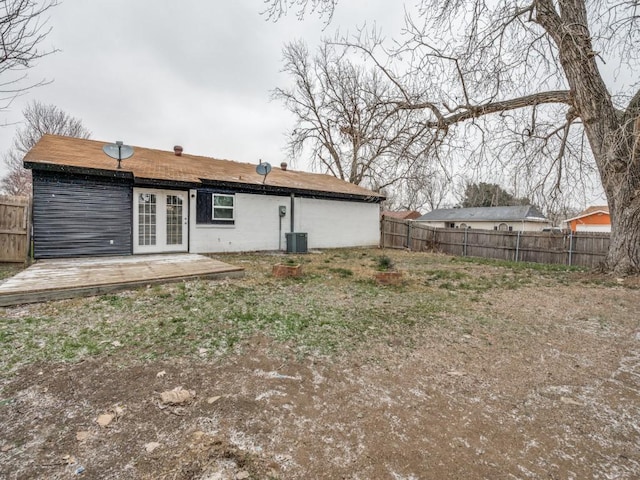 rear view of property featuring french doors and fence