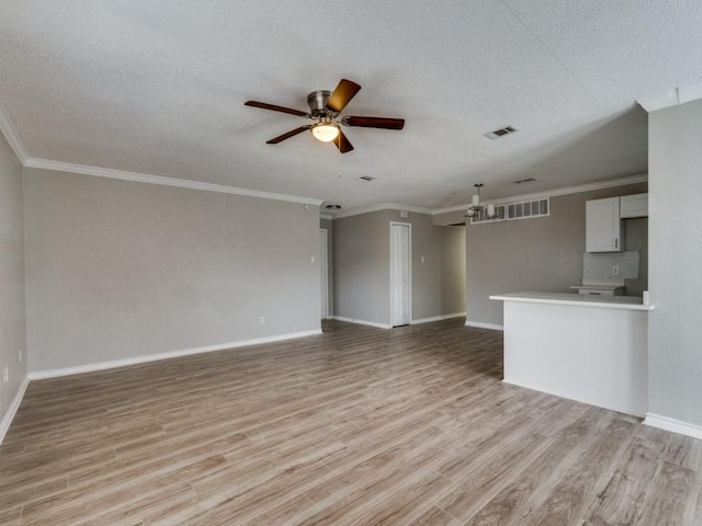 unfurnished living room with a textured ceiling, light wood-style flooring, visible vents, a ceiling fan, and ornamental molding