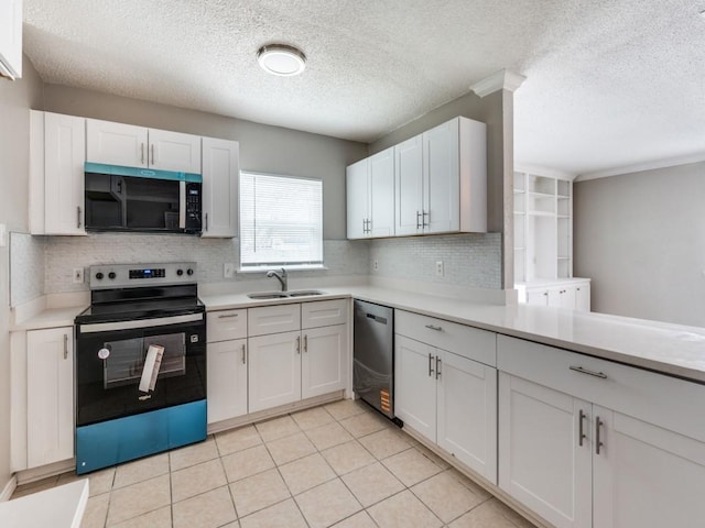 kitchen with stainless steel appliances, a sink, white cabinetry, light countertops, and decorative backsplash