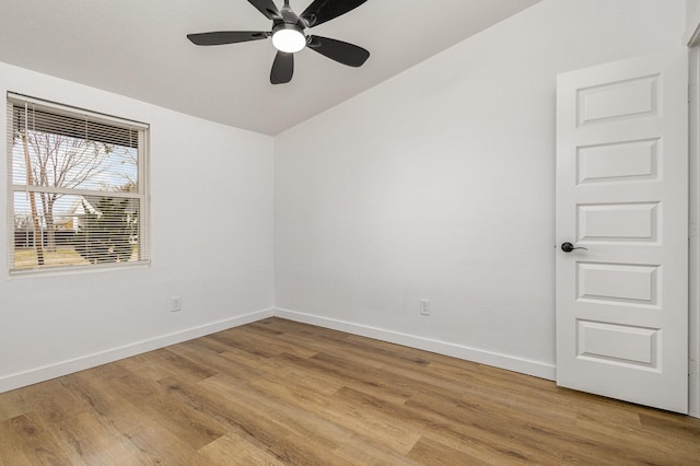 unfurnished room with light wood finished floors, baseboards, and a ceiling fan