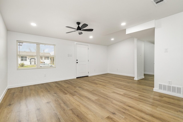 interior space with light wood finished floors, visible vents, and recessed lighting