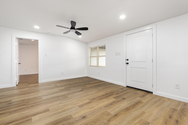 spare room featuring recessed lighting, a ceiling fan, baseboards, vaulted ceiling, and light wood finished floors