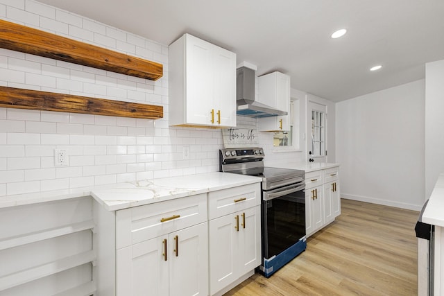 kitchen featuring tasteful backsplash, white cabinetry, electric range, and wall chimney exhaust hood