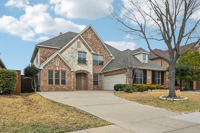 traditional-style house featuring an attached garage, brick siding, stone siding, driveway, and roof with shingles